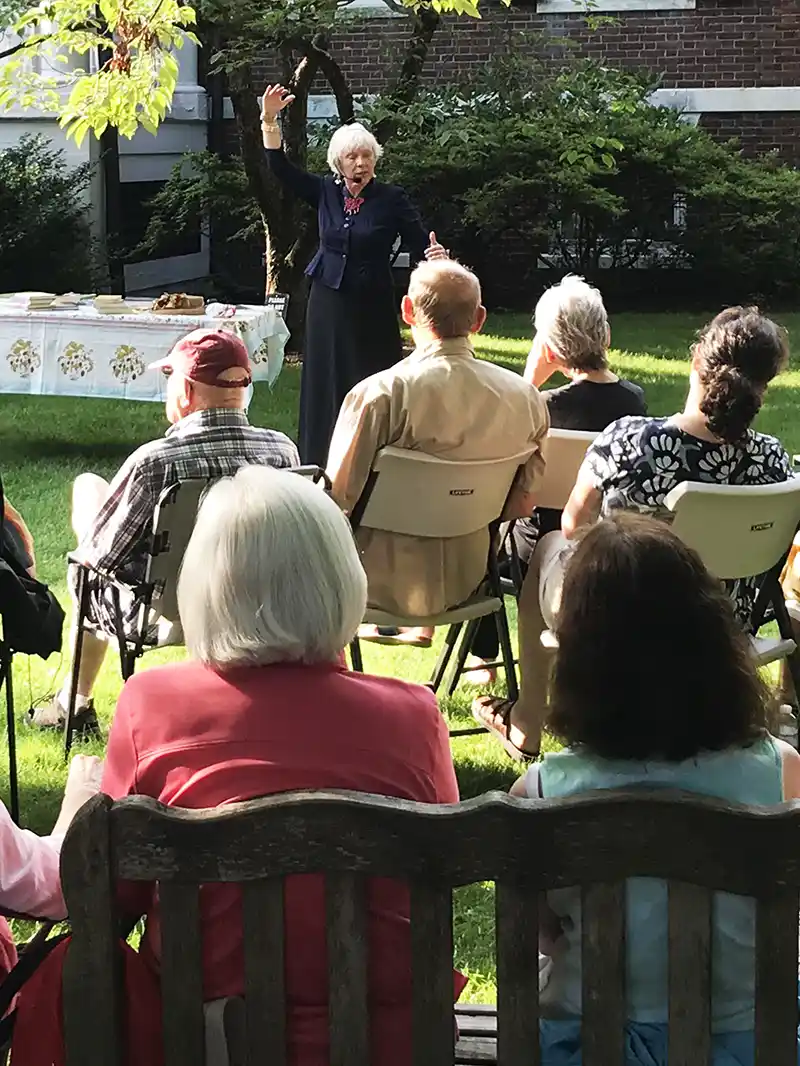 Photo of people listening to a speaker in the Athenaeum garden