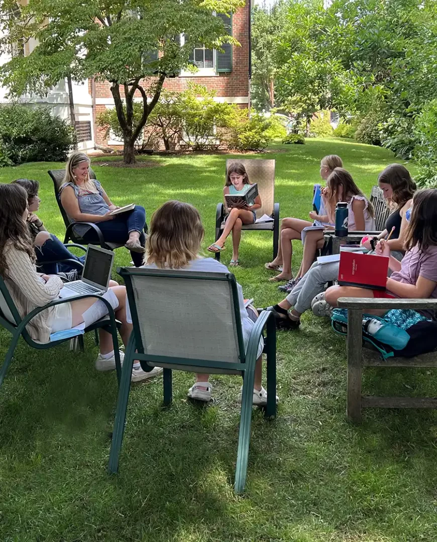 Photo of children in a reading circle in the Athenaeum garden